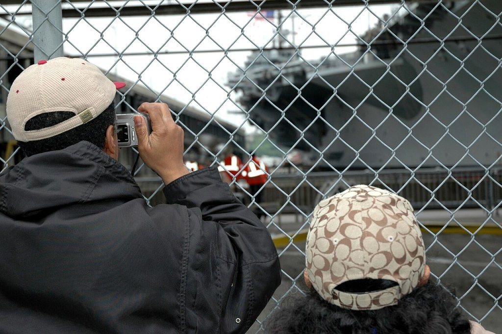 New Yorkers take a moment to photograph the arrival of the carrier John F