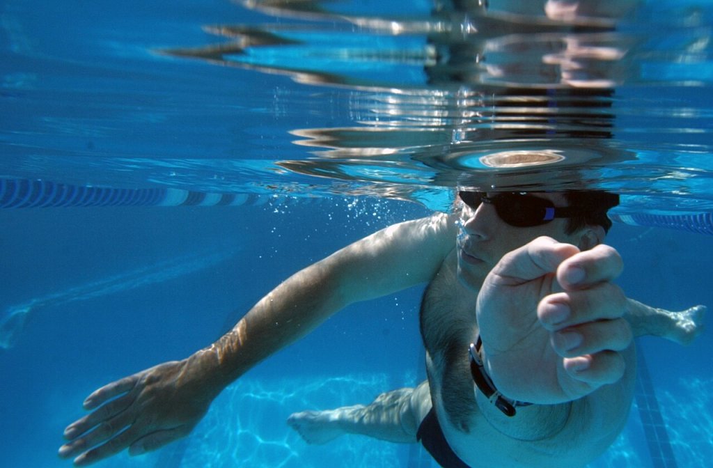 Photographer's mate 1st class Bart Bauer, of Billings, Montana, stays in shape by swimming at nav...
