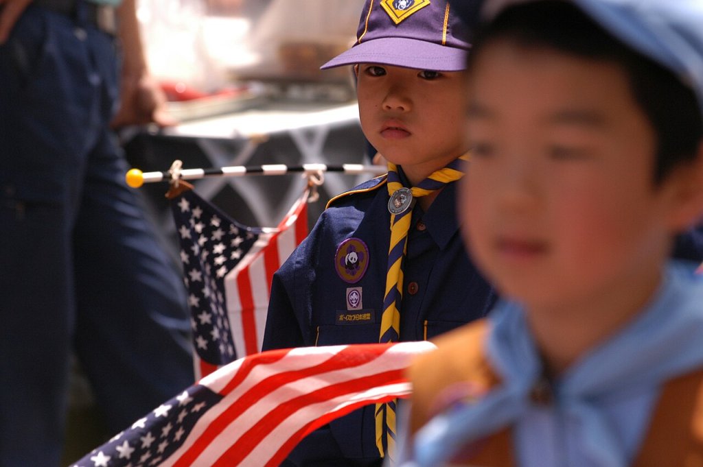 A young Japanese Cub Scout marches in a parade during the 65th Shimoda Black Ship Festival
