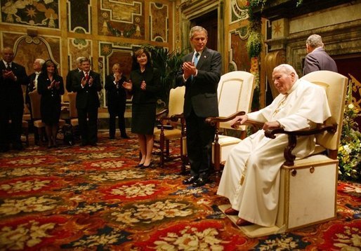 President George W Bush and Mrs Laura Bush stand and applaud Pope John Paul II