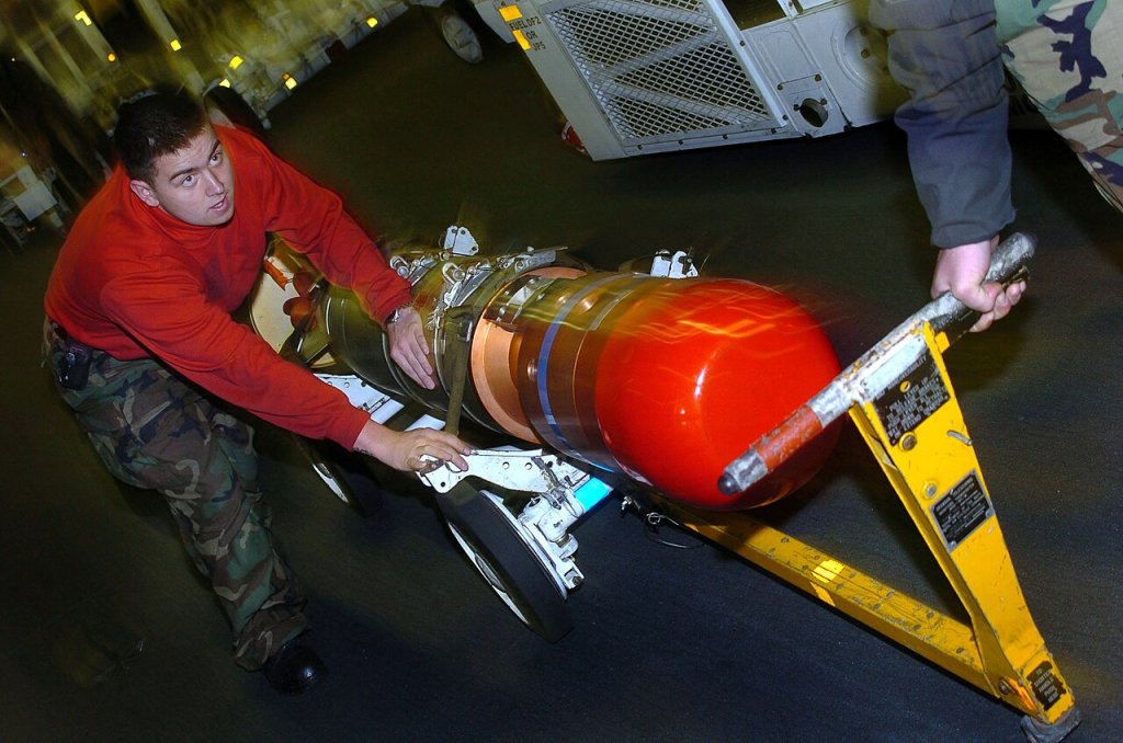Aviation Ordnanceman Airman Edward Lopez, of Calexico, Calif., transits through the hanger bay wi...