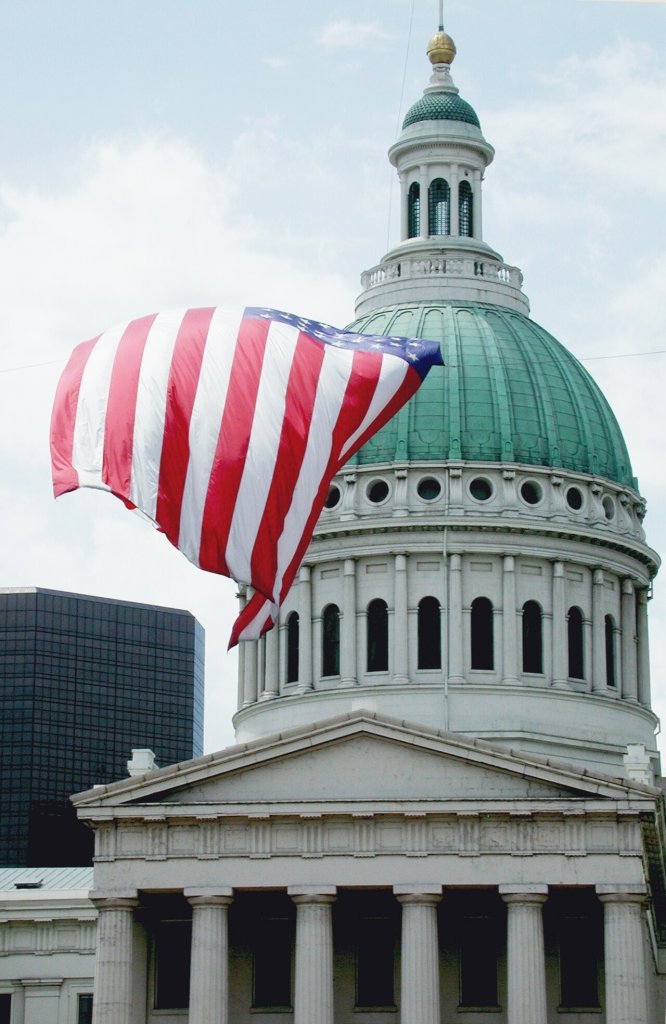 Old Courthouse dome with large flag flying in foreground