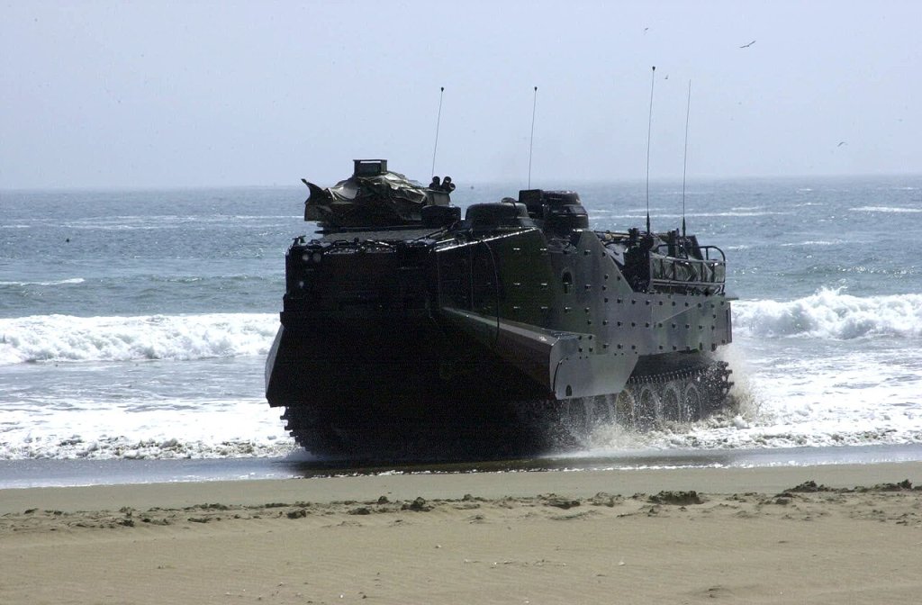 An amphibious assault vehicle (AAV) rolls out of the water to pick up Marines from the U.S., Peru...