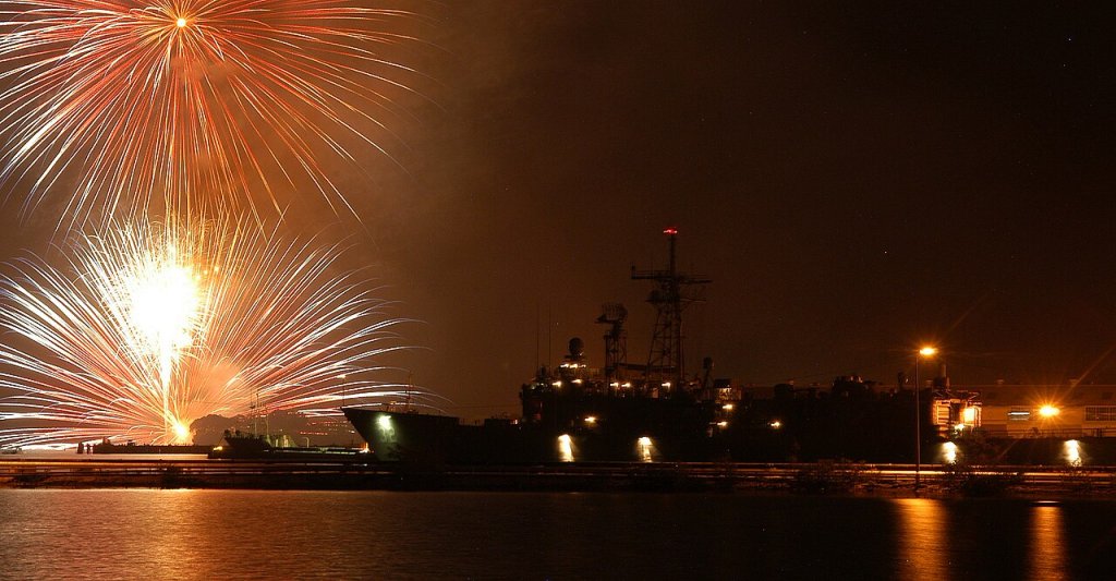 Fireworks explode above the guided missile frigate USS John L