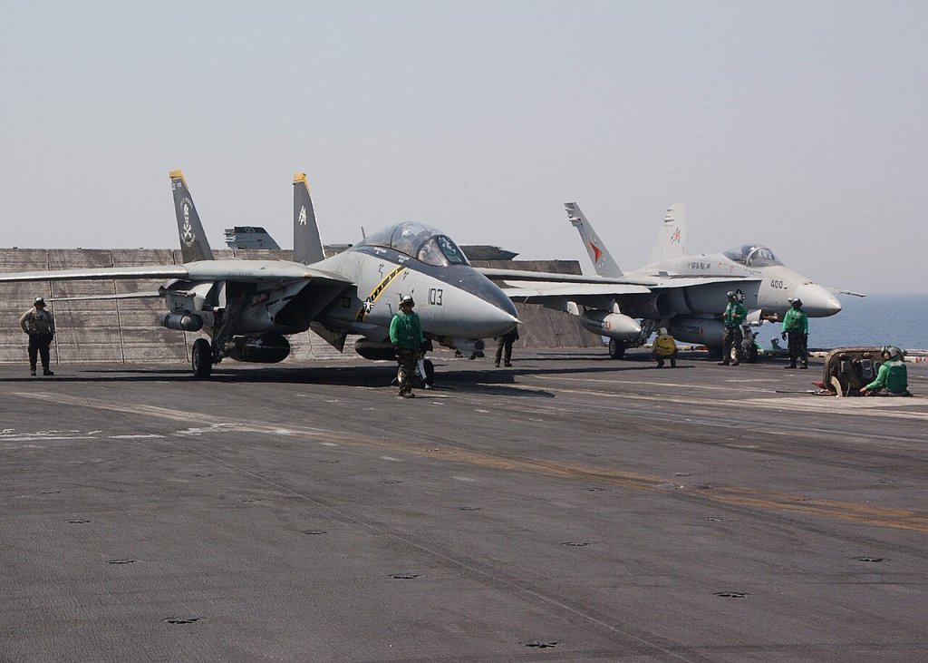An F-14D Tomcat assigned to the "Jolly Rogers" of Fighter Squadron 103 (VF-103) and an F/A-18...