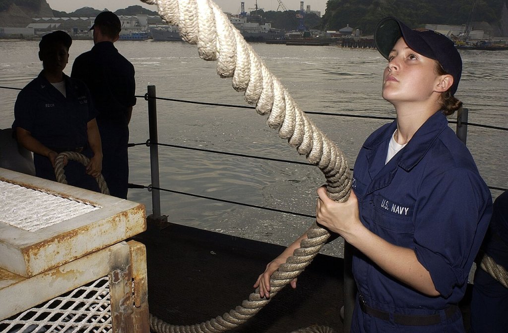 Seaman Maria Garcia, from Lakeland, Minn., stows a mooring line as USS Kitty Hawk (CV 63) departs...