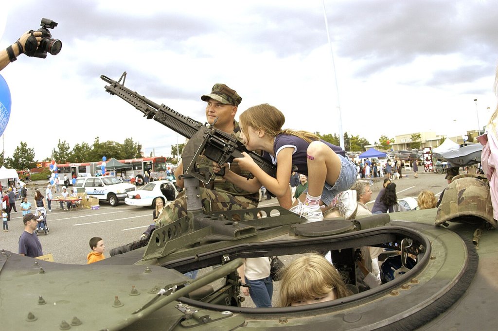 Master At Arms 2nd Class Michael Hinton, assigned to Naval Station Everett, helps local children ...