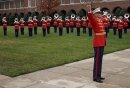 MARINE BARRACKS WASHINGTON ? The director of the Marine Drum and Bugle Corps signals the opposi...