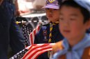 A young Japanese Cub Scout marches in a parade during the 65th Shimoda Black Ship Festival