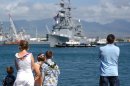 Family and friends watch as the Spruance Class destroyer USS Fletcher (DD 992) is guided to a pie...