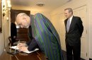 Afghan President Hamid Karzai signs the guest book at the Pentagon