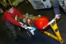 Aviation Ordnanceman Airman Edward Lopez, of Calexico, Calif., transits through the hanger bay wi...