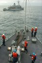 The mine countermeasure ship USS Scout (MCM 8), conducts a tow and be towed exercise with USS Sen...