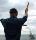 Quartermaster 1st Class Jesse Gaytan assigned to mine countermeasure ship USS Scout (MCM 8) commu...