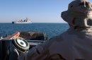 Equipment is off-loaded from the amphibious dock landing ship USS Whidbey Island (LSD 41) using a...