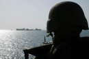 Gunner's Mate 3rd Class Mathew McClelland stands watch on a M-60 machine gun mount aboard the des...