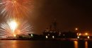 Fireworks explode above the guided missile frigate USS John L