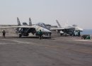 An F-14D Tomcat assigned to the "Jolly Rogers" of Fighter Squadron 103 (VF-103) and an F/A-18...