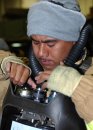 Aviation Ordnanceman 2nd Class Fong Sii, of Honolulu, Hawaii, dons his Oxygen Breathing Apparatus...