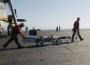 Aviation Ordnancemen transfer Guided Bomb Unit Twelve (GBU-12) bombs to an F/A-18 Hornet for ordn...