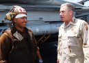 A member of the flight deck crew speaks with General John Abizaid, Commander, U.S