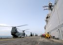 The flight deck crew aboard the amphibious assault ship USS Wasp (LHD 1) welcomes back CH-46 Sea ...