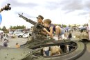 Master At Arms 2nd Class Michael Hinton, assigned to Naval Station Everett, helps local children ...