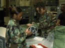 U S Air Force 99th Services Squadron Airman 1st Class Monica Pitt, checks out Chemical Warfare ge...