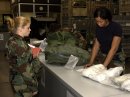 U S Air Force 99th Services Squadron Airman 1st Class Tanya Hebert, checks out Chemical Warfare g...